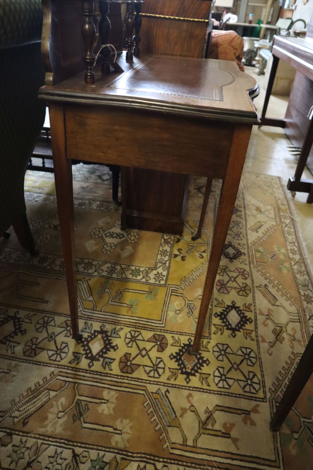 A late Victorian satinwood banded mahogany bowfront writing table, width 76cm, depth 45cm, height 115cm